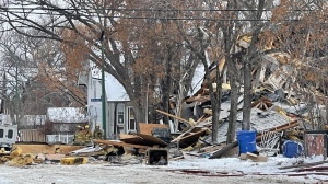 The multi-story residence at the centre of the incident can be seen in ruins. (Brianne Foley/CTV News)