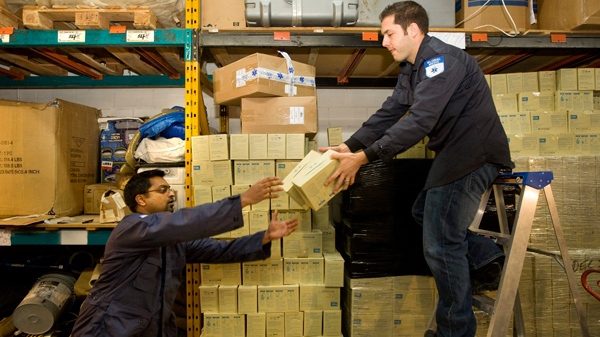 GlobalMedic volunteer Sean D'Souza, left, and Emergency Program manager Matt Capobianco prepare boxes of supplies destined for Haiti, at their Toronto headquarters, on Wednesday, Jan. 13, 2010. (Darren Calabrese / THE CANADIAN PRESS)