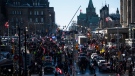 People and vehicles fill Wellington Street near Parliament Hill during a rally against COVID-19 restrictions, which began as a cross-country convoy protesting a federal vaccine mandate for truckers, in Ottawa, on Saturday, Jan. 29, 2022. THE CANADIAN PRESS/Justin Tang