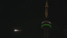 A meteor can be seen with the CN Tower in the foreground. (EarthCam)