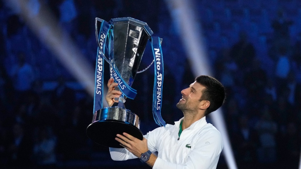 Novak Djokovic poses with his trophy
