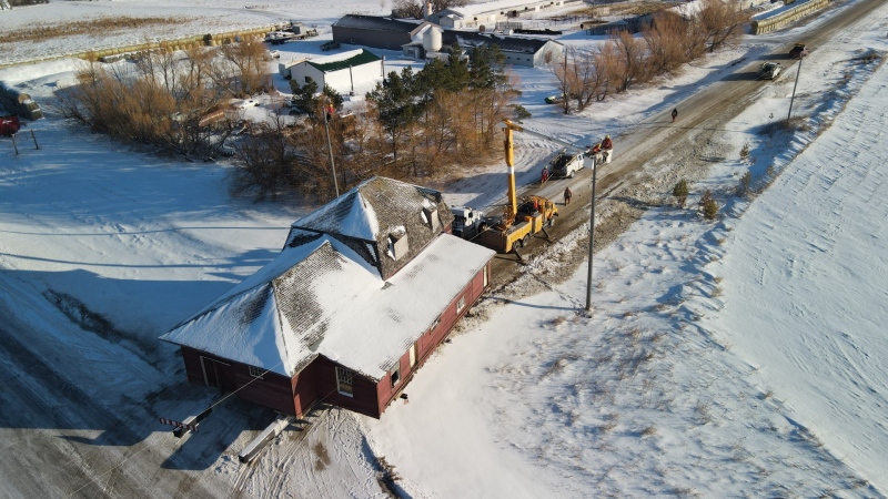 The La Riviere station house on the move to its new permanent location in Manitou, Man. Nov. 22, 2022. (Source: Currie Country Living)
