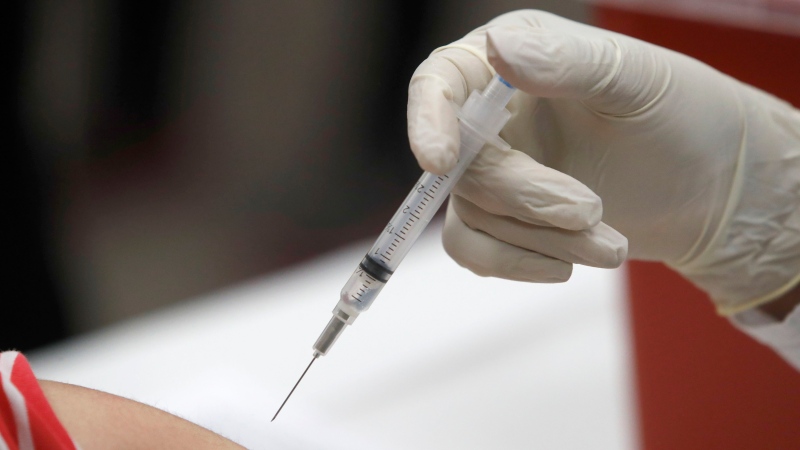 FILE - This Jan. 23, 2020 file photo shows a patient receiving a flu vaccination in Mesquite, Texas. (AP Photo/LM Otero, File)