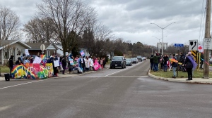 Protesters and counter-protesters gather along Barnet Street in Renfrew outside of St. Joseph's High School on Friday. (Dylan Dyson/CTV News Ottawa) 