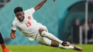 Canada forward Alphonso Davies (19) falls to the turf after he gets tripped up against Belgium during second half group F World Cup soccer action at the Ahmad Bin Ali Stadium in Al Rayyan, Qatar on Thursday, November 23, 2022. THE CANADIAN PRESS/Nathan Denette 