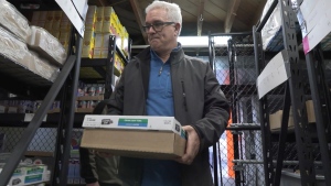 Ben Molesky, director of the Sooke Food Bank, stocks shelves in preparation for Christmas hamper season. (CTV)