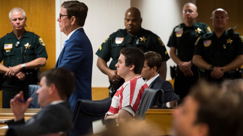 Austin Harrouff, center, wearing stripes, accused of brutally killing a Tequesta couple in 2016, appears Friday, Aug. 2, 2019, at the Martin County Courthouse in Stuart, Fla., as defense attorney Robert Watson, standing in front of Harrouff, asks Martin County Circuit Judge Sherwood Bauer Jr., to not allow video recording of a mental health evaluation to be conducted by a psychologist hired by the state. Harrouff, a former college student who killed a Florida couple in their garage six years earlier and then chewed on one victim's face, is finally set to go on trial, Monday, Nov. 21, 2022. (Xavier Mascarenas/TCPalm.com via AP, File)