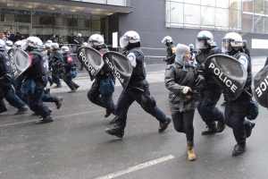 Riot police charge during an anti-police brutality demonstration in Montreal, Friday, March 15, 2013. The City of Montreal will pay more than $3 million to hundreds of protestors whose rights were violated by city police. THE CANADIAN PRESS/Ryan Remiorz