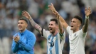 Argentina's forward Lionel Messi, middle, reacts with Argentina's forward Lautaro Martinez, right, at the final whistle of the Qatar 2022 World Cup Group C football match between Argentina and Mexico at the Lusail Stadium in Lusail, north of Doha on Nov. 26, 2022. (Photo by Juan Mabromata/AFP via Getty Images)