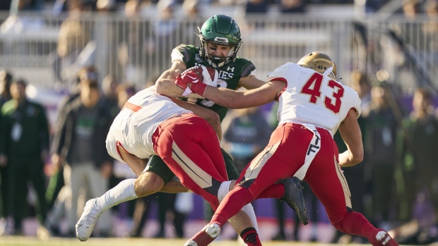 Jordin Rusnack of the Saskatchewan Huskies is tackled by Laval’s Francis Bouchard(1) and Charles Alexandre Jacques (43) during the U Sports Vanier Cup in London, Ont., Saturday, Nov. 26, 2022. THE CANADIAN PRESS/Geoff Robins
