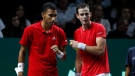 Canada's Vasek Pospisil, right, speaks to Felix Auger Aliassime during the semi-final Davis Cup tennis doubles match between Italy and Canada in Malaga, Spain, Saturday, Nov. 26, 2022. (AP Photo/Joan Monfort)