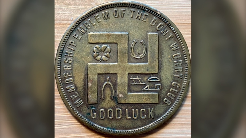 In this photo provided by Holocaust researcher Jeff Kelman in November 2022, the swastika is seen on a coupon-type store token made before the Nazi Party adopted the symbol. This is part of Kelman's collection, which he says shows the "regular and innocuous use of the swastika as a symbol of good fortune in the West, prior to the Nazi use of the similar-looking hakenkreuz." (Jeff Kelman via AP)