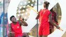 Canada forward Alphonso Davies, left, and defender Sam Adekugbe joke around during practice at the World Cup in Doha, Qatar on Monday, November 28, 2022. THE CANADIAN PRESS/Nathan Denette