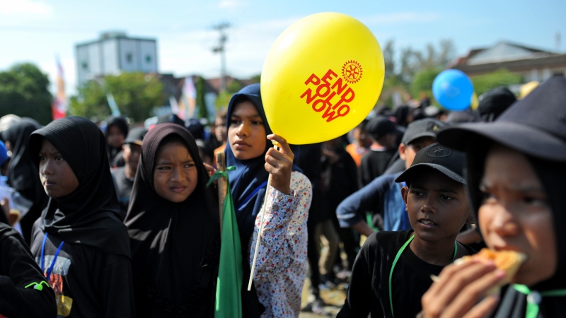 Children queue up for their turn to be vaccinated against poliovirus during a polio immunization campaign at Sigli Town Square in Pidie, Aceh province, Indonesia, Monday, Nov. 28, 2022. Indonesia has begun a campaign against the poliovirus in the the country's conservative province after several children were found infected with the highly-contagious disease that was declared eradicated in the country less than a decade ago. (AP Photo/Riska Munawarah)