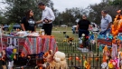 Sandra Cruz Torres, mother of Robb Elementary massacre victim Eliahna Torres, chats with Beto O'Rourke, Democratic candidate running for governor, as Cruz and her family celebrate DÃ­a de los Muertos at Torres' gravesite in Hillcrest Memorial Cemetery in Uvalde, Texas, Nov. 2, 2022. Sandra Cruz Torres filed a federal lawsuit on Monday, Nov. 28, against the police, the school district and the maker of the gun used in the massacre. (Sam Owens/The San Antonio Express-News via AP, File)