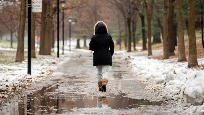 A person walks through a park in Montreal, Saturday, Dec. 11, 2021. THE CANADIAN PRESS/Graham Hughes
