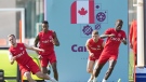 Canada forward Liam Millar, left, midfielder Mark-Anthony Kaye, second left, midfielder David Wotherspoon, second right, and forward Ike Ugbo, right, run a drill during practice at the World Cup in Doha, Qatar on Monday, November 28, 2022. THE CANADIAN PRESS/Nathan Denette