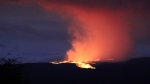 Lava pours out of the summit crater of Mauna Loa about 6:35 a.m. Monday, Nov. 28, 2022, as seen from Gilbert Kahele Recreation Area on Maunakea, Hawaii. (Chelsea Jensen/West Hawaii Today via AP) 