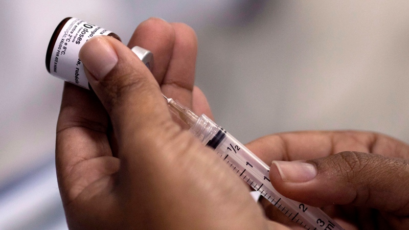 In this Monday, Aug. 6, 2018, file photo, a health worker prepares a syringe with a vaccine against measles in Rio de Janeiro, Brazil. (AP Photo/Leo Correa, File)