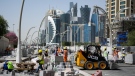 Construction workers renew paths in downtown Doha on March 20, 2022, Qatar, Doha. Numerous streets were redesigned in the run-up to the World Cup. Qatar is repeatedly criticized for its treatment of foreign workers. (Photo by Bernd von Jutrczenka/Getty Images)