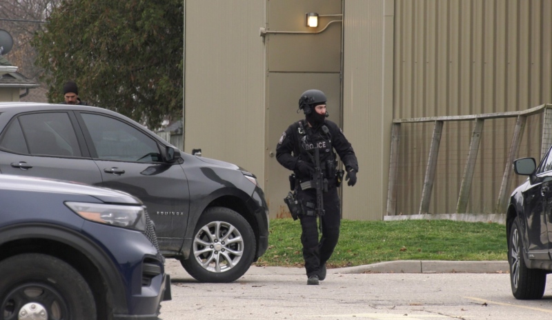 Police officers in tactical gear could be seen at the scene of a suspicious death in Woodstock on Nov. 29, 2022. (Gerry Dewan/CTV News London)