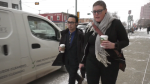 Thomas Dang, left, leaves Edmonton provincial court on Nov. 29, 2022, after being fined $7,200 for hacking Alberta's online vaccine portal in 2021 as an NDP MLA. 