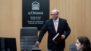 Justice William Hourigan, Commissioner of the Ottawa Light Rail Transit Commission, takes his seat before the start of the first day of proceedings at the inquiry into the troubled LRT system in Ottawa, on Monday, June 13, 2022. (Justin Tang/THE CANADIAN PRESS)