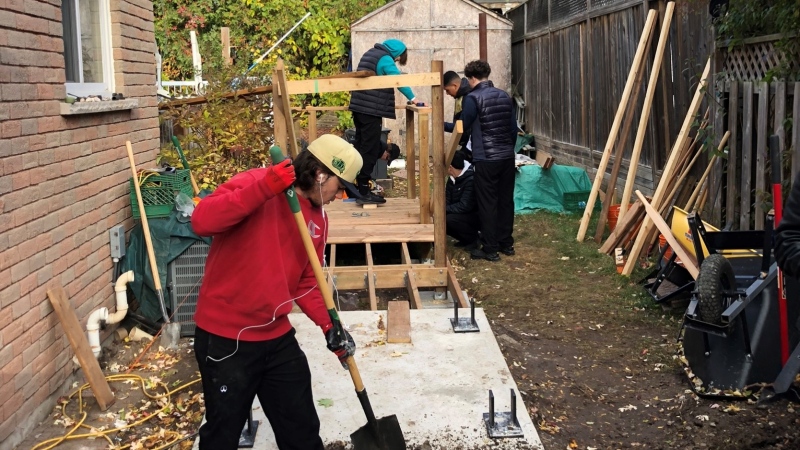 Grade 11 construction students from at St. James Catholic High build an accessible ramp at a Guelph home. (Submitted/Jerry Della Savia)