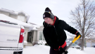 Dakota Kiss shovels out from a snow storm that hit Saskatoon this week. (Carla Shynkaruk/CTV News)