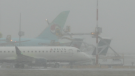 Planes are seen on the Vancouver International Airport tarmac during a snowstorm on Nov. 29, 2022.