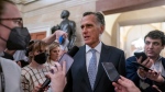 Sen. Mitt Romney, R-Utah, is surrounded by reporters as he arrives at the historic Old Senate Chamber at the Capitol in Washington, Nov. 16, 2022. In 2024 Romney will face his first Senate reelection bid, if he chooses to run. Romney remains popular with many residents in Utah but has faced backlash from his own party for being the only Republican who voted twice to remove Trump from office after his two impeachments by the House. (AP Photo/J. Scott Applewhite, File)