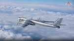 In this handout photo taken from video released by the Russian Defense Ministry Press Service on Wednesday, Nov. 30, 2022, a Tu-95 strategic bomber of the Russian air force flies as part of a joint patrol with Chinese bombers over the Pacific. Russian and Chinese strategic bombers on Wednesday flew a joint patrol over the western Pacific in a show of increasingly close defense ties between the two countries. (Russian Defense Ministry Press Service via AP)