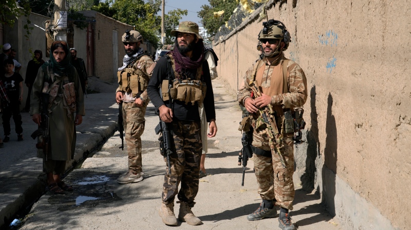 Taliban fighters stand guard in front of an education center that was attacked by a suicide bomber, in Kabul, Afghanistan, Friday, Sept. 30, 2022. A Taliban official says that at least 10 students were killed Wednesday when a bomb blast hit a religious school in northern Afghanistan.(AP Photo/Ebrahim Noroozi)