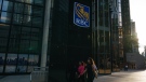 People walk past a Royal Bank of Canada sign in the financial district in Toronto on Tuesday, Sept. 20, 2022. (THE CANADIAN PRESS/Alex Lupul)