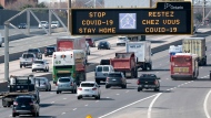 Traffic on Highway 401 in Toronto passes under a COVID-19 sign on Monday April 6, 2020.  THE CANADIAN PRESS/Frank Gunn