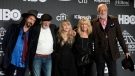 FILE - This March 29, 2019 file photo shows Inductee Stevie Nicks, center, posing with other members of Fleetwood Mac, from left, Mike Campbell, John McVie, Christine McVie and Mick Fleetwood at the Rock & Roll Hall of Fame induction ceremony in New York. (Photo by Charles Sykes/Invision/AP, File)