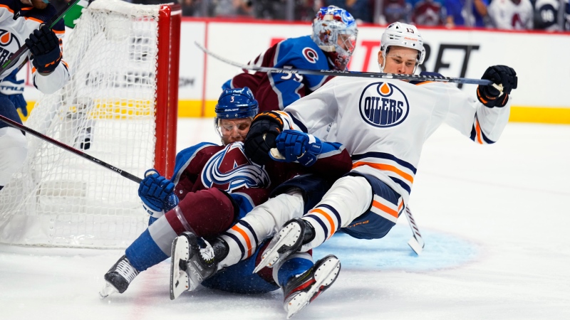 Colorado Avalanche defenseman Jack Johnson (3) pulls down Edmonton Oilers right wing Jesse Puljujarvi (13) during the first period in Game 2 of the NHL hockey Stanley Cup playoffs Western Conference finals Thursday, June 2, 2022, in Denver. (AP Photo/Jack Dempsey)