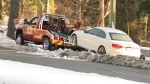 A tow truck removes an abandoned car from the side of the Malahat highway on Nov. 30, 2022. (CTV News)