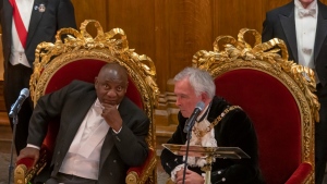South Africa President Cyril Ramaphosa, left, and Lord Mayor of the City of London Nicholas Lyons speak at a banquet in the Guildhall, in London, on Nov. 23, 2022. (Kin Cheung / AP) 