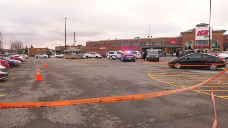 Police tape surrounds the parking lot at the IGA supermarket at 7150 Langelier Blvd. in Montreal's St-Leonard borough after a report of gunshots being fired on Thursday, Dec. 1, 2022. (CTV News)