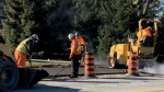 Workers continue paving the Ganatchio Trail extension on Riverside Drive in Windsor, Ont. on Thursday, Dec. 1, 2022. (Chris Campbell/CTV News Windsor)
