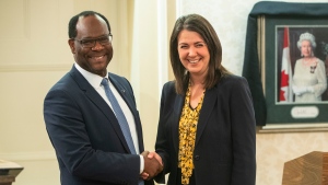 Kaycee Madu shakes hands with Alberta Premier Danielle Smith, in Edmonton, Monday, Oct. 24, 2022. Madu, Alberta’s deputy premier, says the proposed sovereignty bill does not grant cabinet unilateral power to rewrite laws behind closed doors, but amendments may be needed to clear that up. THE CANADIAN PRESS/Jason Franson