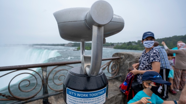 People look out onto the Horseshoe Falls in Niagara Falls, Ontario on Friday, July 16, 2021. THE CANADIAN PRESS/Peter Power