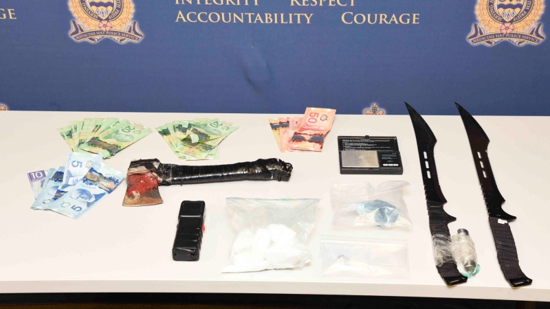 Swords, drugs, cash and other weapons seized during a Nov. 25 traffic stop in Medicine Hat. (image: MHPS)