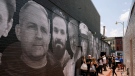 Paul Whelan is pictured, top left, on a mural in Washington depicting hostages and wrongful detainees, on July 20, 2022. (Patrick Semansky / AP)