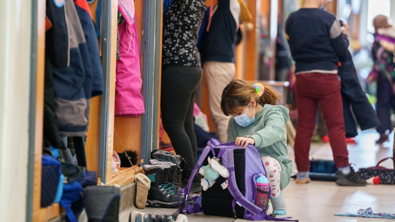 Students in an elementary school get ready for class as Quebec students get back to school in Montreal on Tuesday, January 18, 2022. THE CANADIAN PRESS/Paul Chiasson