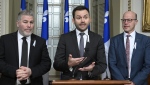 Parti Quebecois Leader Paul St-Pierre Plamondon, flanked by Parti Quebecois MNAs Pascal Berube, left, and Joel Arseneau, reacts to the inaugural speech, at the legislature in Quebec City, Wednesday, Nov. 30, 2022. THE CANADIAN PRESS/Jacques Boissinot