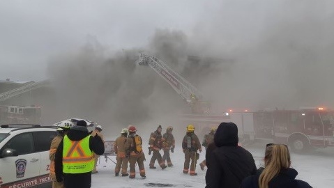 A large plume of smoke hangs over the Mont-Gabriel Hotel in Sainte-Adele, Que. Friday. Firefighters from several municipalities were called to the scene to fight the blaze. 