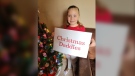 Five-year-old Naomi Hein holds a Christmas Daddies poster. She's raised over $800 for the annual telethon. (Hafsa Arif/CTV)