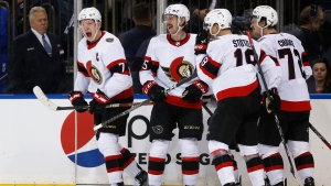 Ottawa Senators left wing Brady Tkachuk, left, celebrates his game-tying goal in the final minute of the third period of the team's NHL hockey game against the New York Rangers Friday, Dec. 2, 2022, in New York. Celebrating with Tkachuk are Jake Sanderson, Tim Stuzle and Thomas Chabot. The Senators won 3-2 on a Tkachuk goal in overtime. (AP Photo/John Munson)